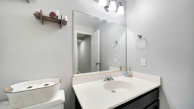a bathroom with a sink toilet and a mirror