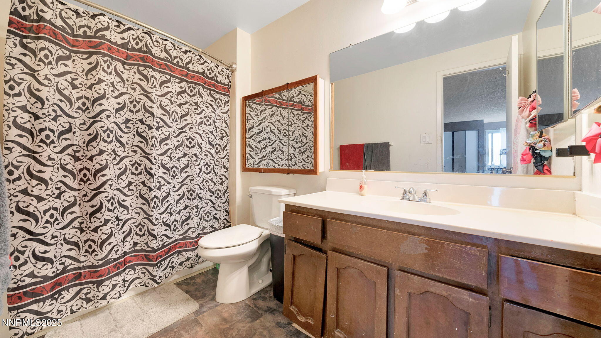 7640 Bluestone Drive Reno, NV 89511 - Photo 28 of 30 a bathroom with a toilet sink and mirror