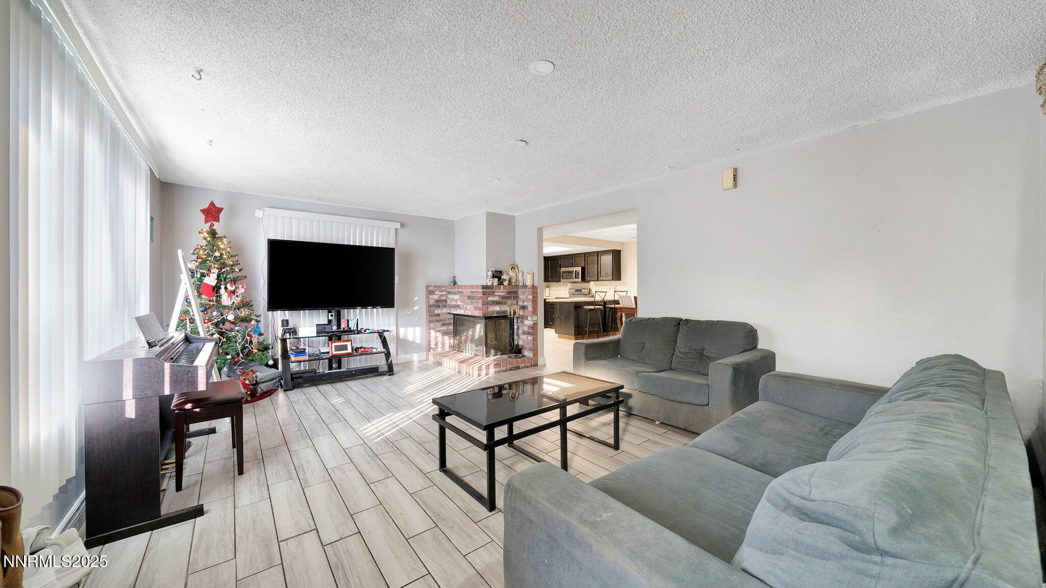 7640 Bluestone Drive Reno, NV 89511 - Photo 7 of 30 a living room with furniture and a flat screen tv
