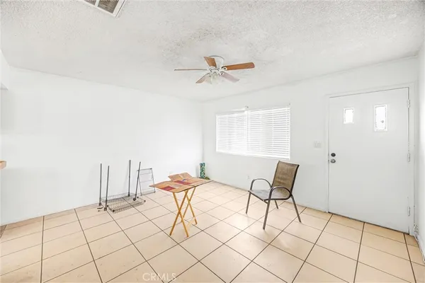 a bedroom with a bed and a chandelier fan