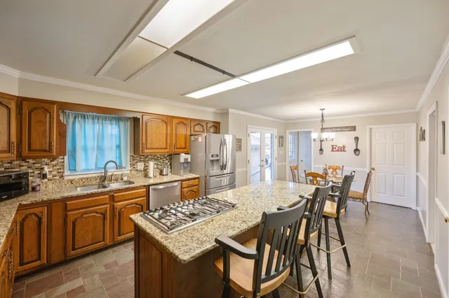 a view of a kitchen with a table and chairs in it