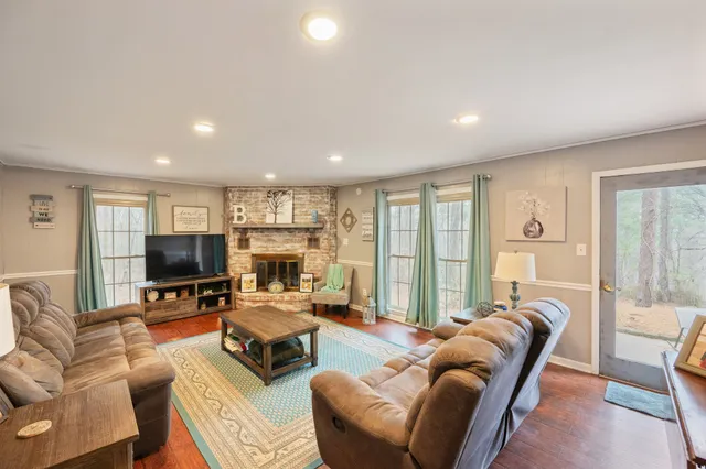 a living room with fireplace furniture and a flat screen tv