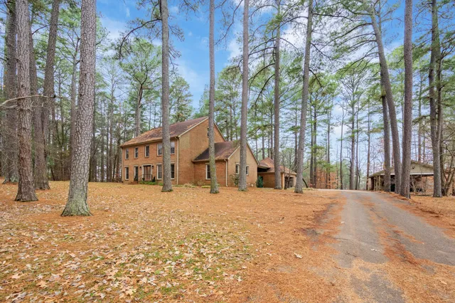 a tall yellow house with a snow in front of it