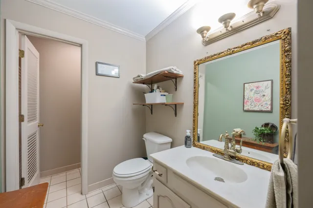 a bathroom with a sink mirror vanity and toilet
