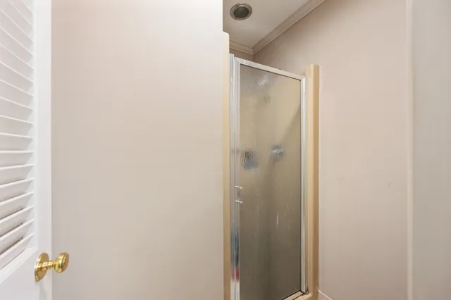 a bathroom with a shower and a mirror