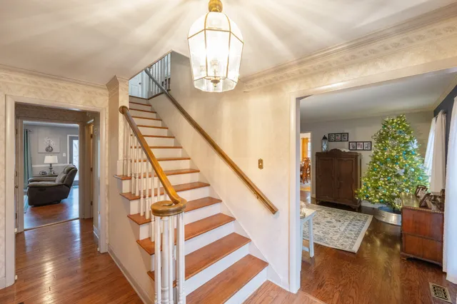 a view of entryway and hall with wooden floor