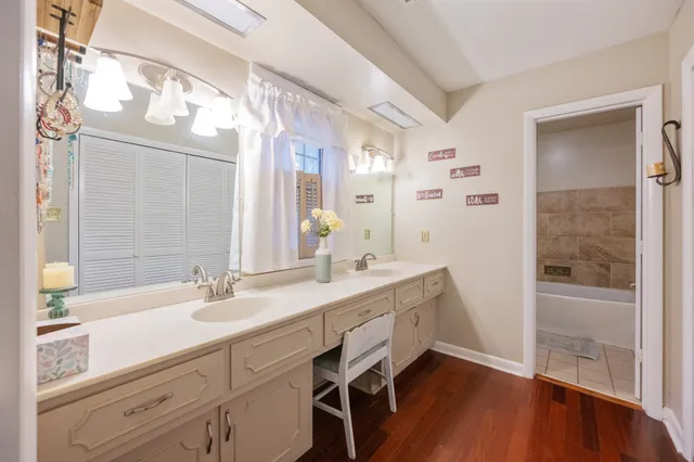 a bathroom with a double vanity sink mirror and shower