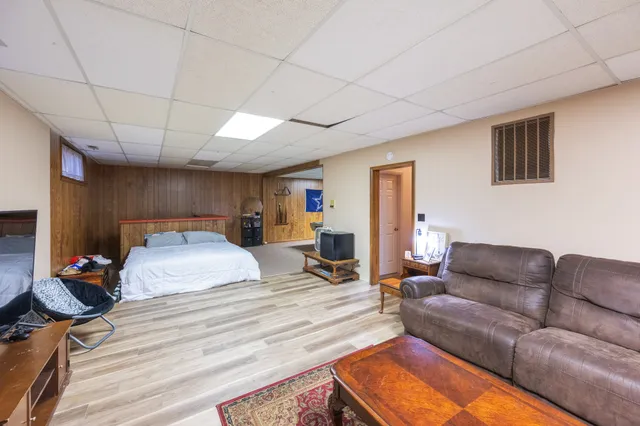 a bedroom with furniture and a chandelier