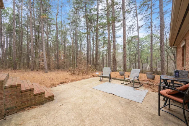 a view of a backyard with chairs
