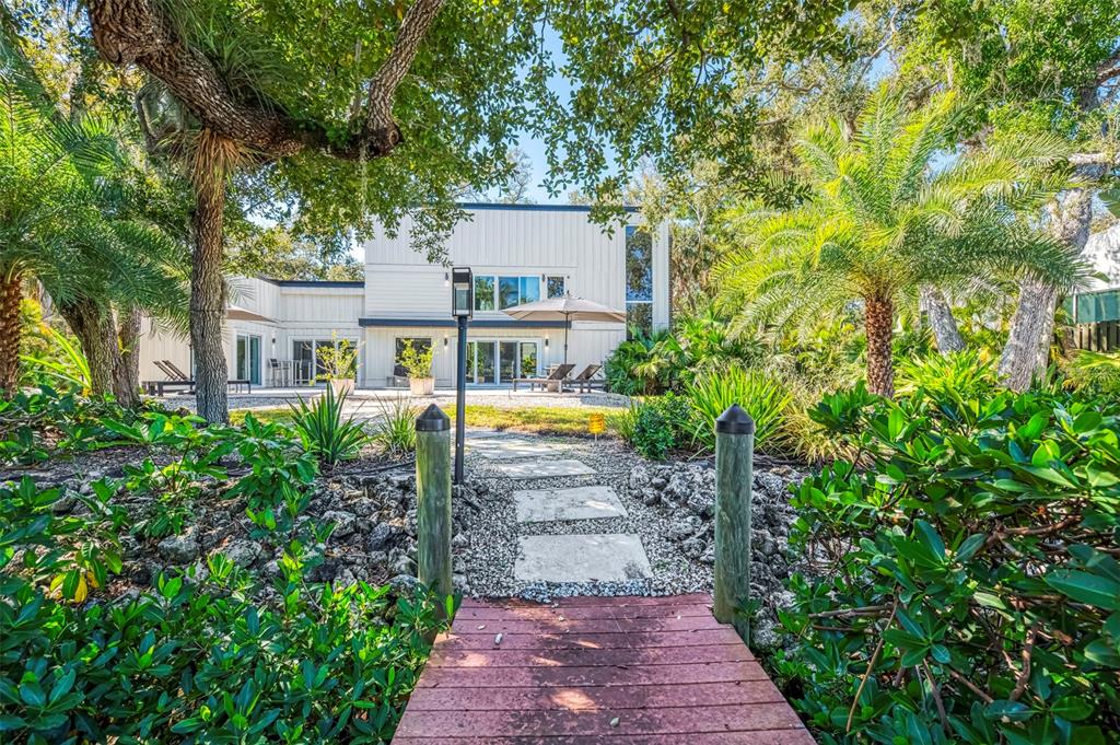 5303 Hidden Harbor Road Sarasota, FL 34242 - Photo 56 of 72 a view of a house with a yard and garden