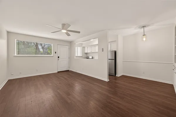 a view of a kitchen with wooden floor and a ceiling fan