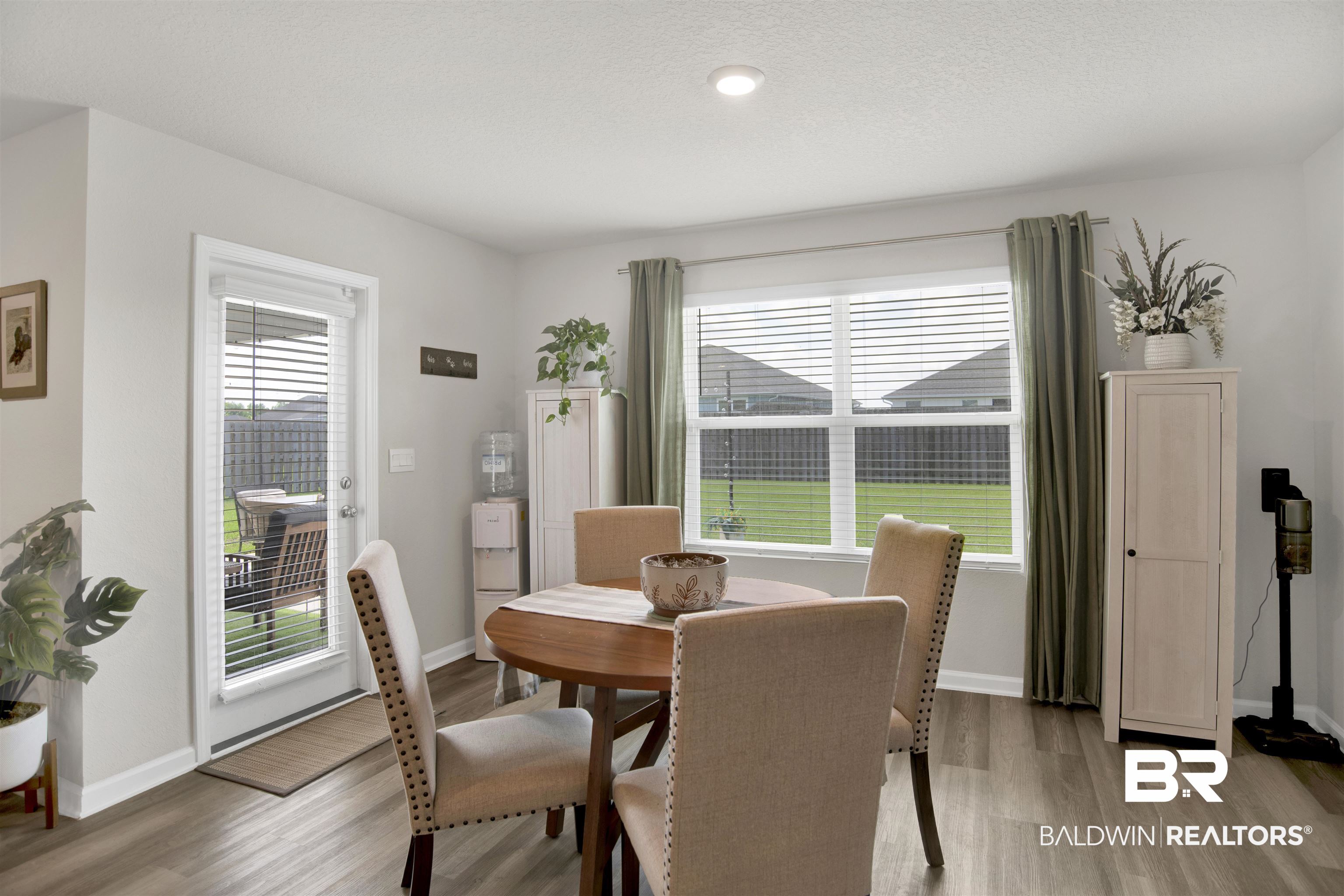 22301 Early Dawn Circle Foley, AL 36535 - Photo 28 of 45 Bright dining area featuring wood-finish flooring and a glass-paneled door opening to the exterior