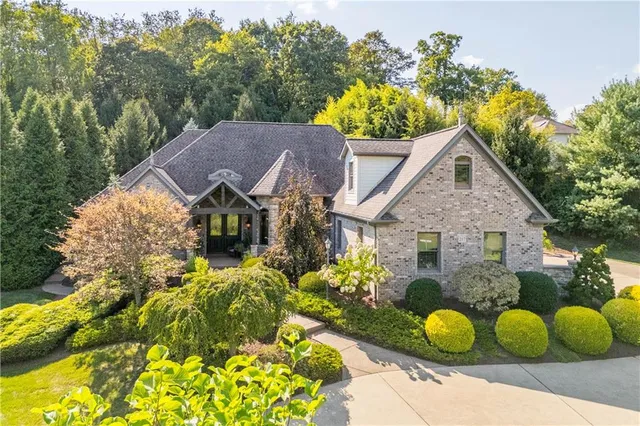 a view of a house with a yard and garden
