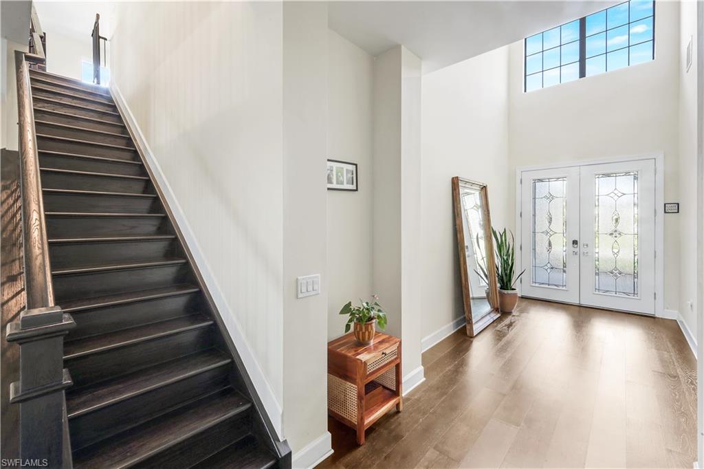 19696 Aqua View Lane Fort Myers, FL 33913 - Photo 26 of 49 a view of a hallway with entryway wooden floor and stairs