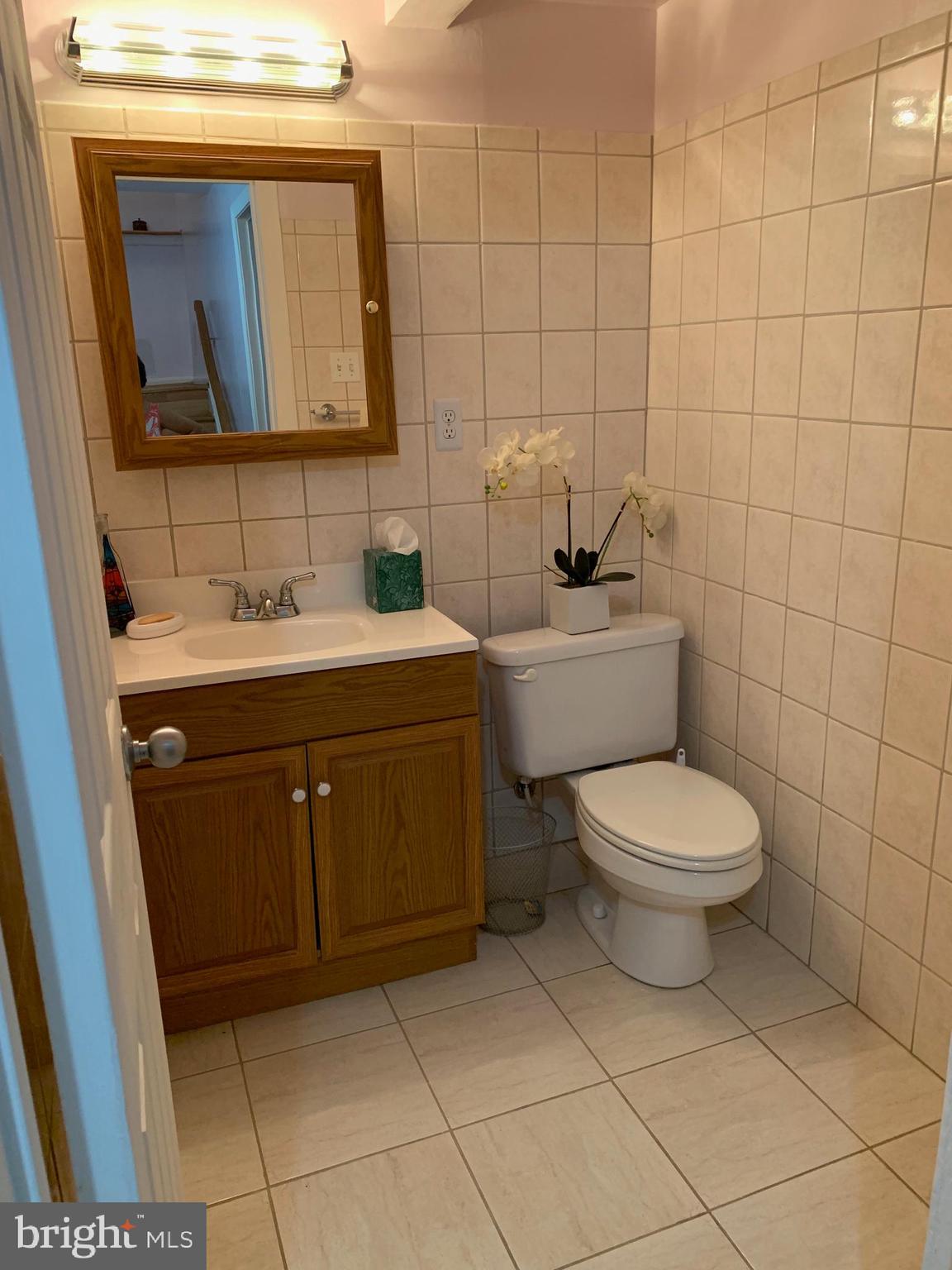 15030 Shamrock Ridge Road Silver Spring, MD 20906 - Photo 16 of 21 Half Bath with Wall Ceramic Tiles and Flooring