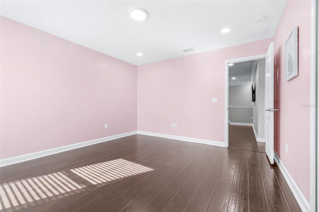 1762 Hadden Hall Place Trinity, FL 34655 - Photo 32 of 49 a view of an empty room with wooden floor and a window
