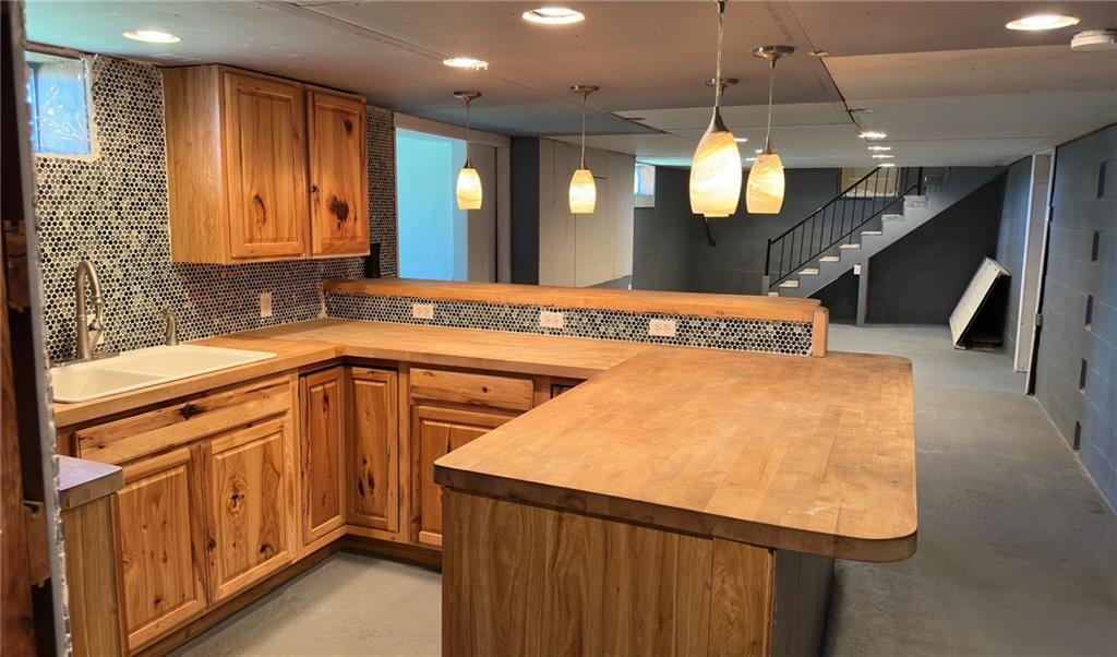 308 Sgros Road Rural Valley, PA 16249 - Photo 17 of 25 a kitchen with kitchen island granite countertop wooden cabinets and a sink