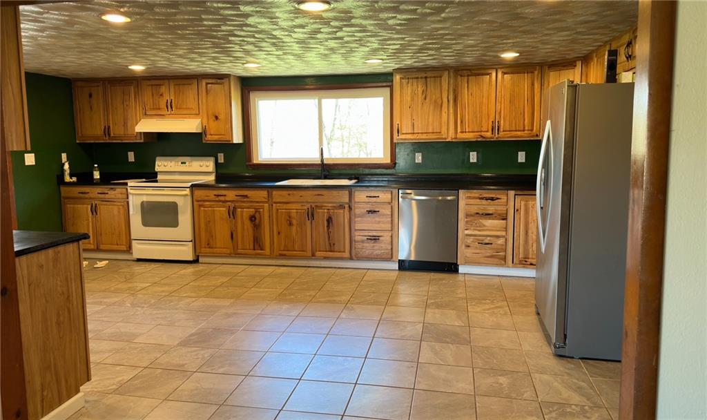 308 Sgros Road Rural Valley, PA 16249 - Photo 6 of 25 a large kitchen with stainless steel appliances granite countertop a stove a sink and a microwave