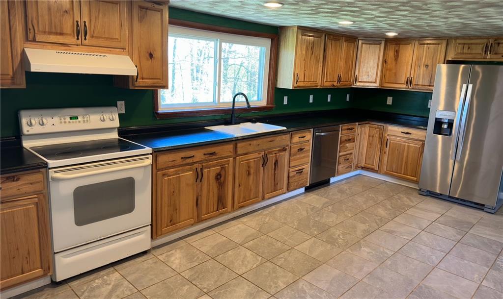 308 Sgros Road Rural Valley, PA 16249 - Photo 8 of 25 a kitchen with stainless steel appliances a stove a sink and a microwave