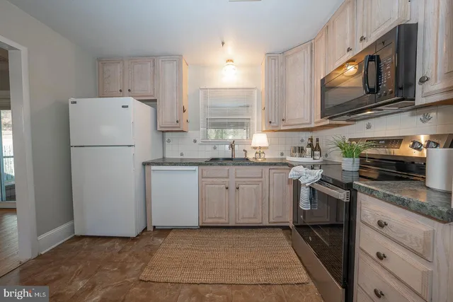 a kitchen with a refrigerator sink and microwave