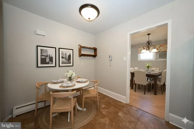 a view of a dining room with furniture and chandelier