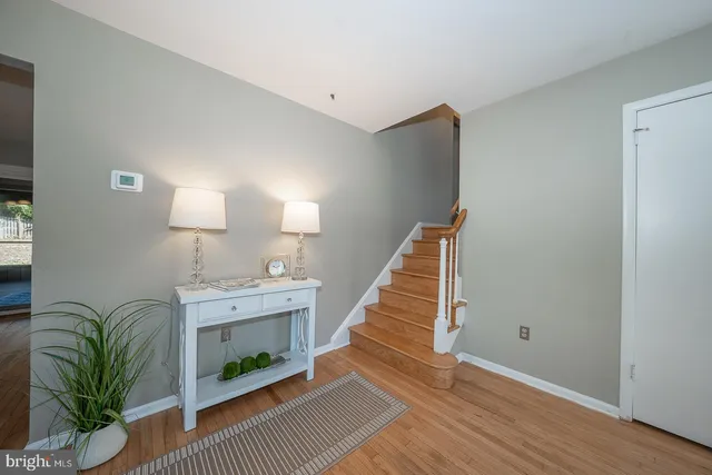 a view of entryway and hall with wooden floor