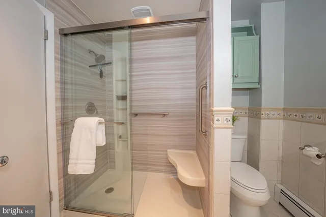 a bathroom with a shower and toilet