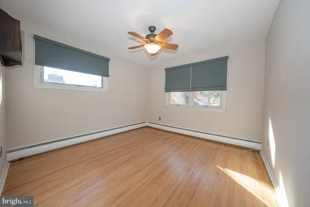 a view of wooden floor chandelier and window in a room