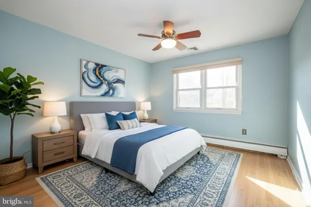 a bedroom with a large bed and a chandelier