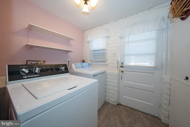 a utility room with closet dryer and washer
