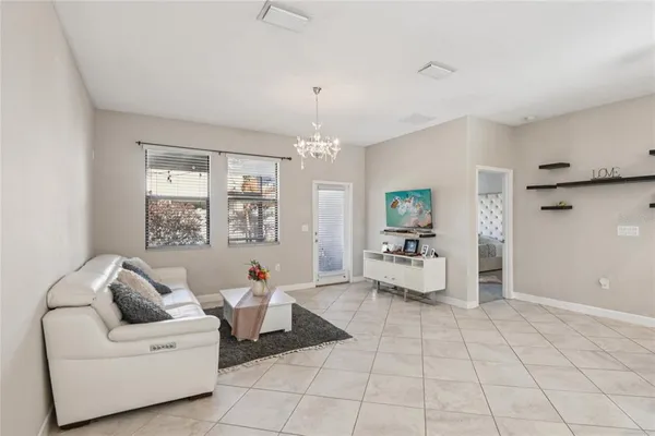 a living room with furniture and a chandelier