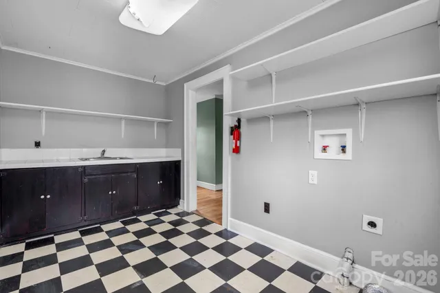 a room with a sink and a mirror