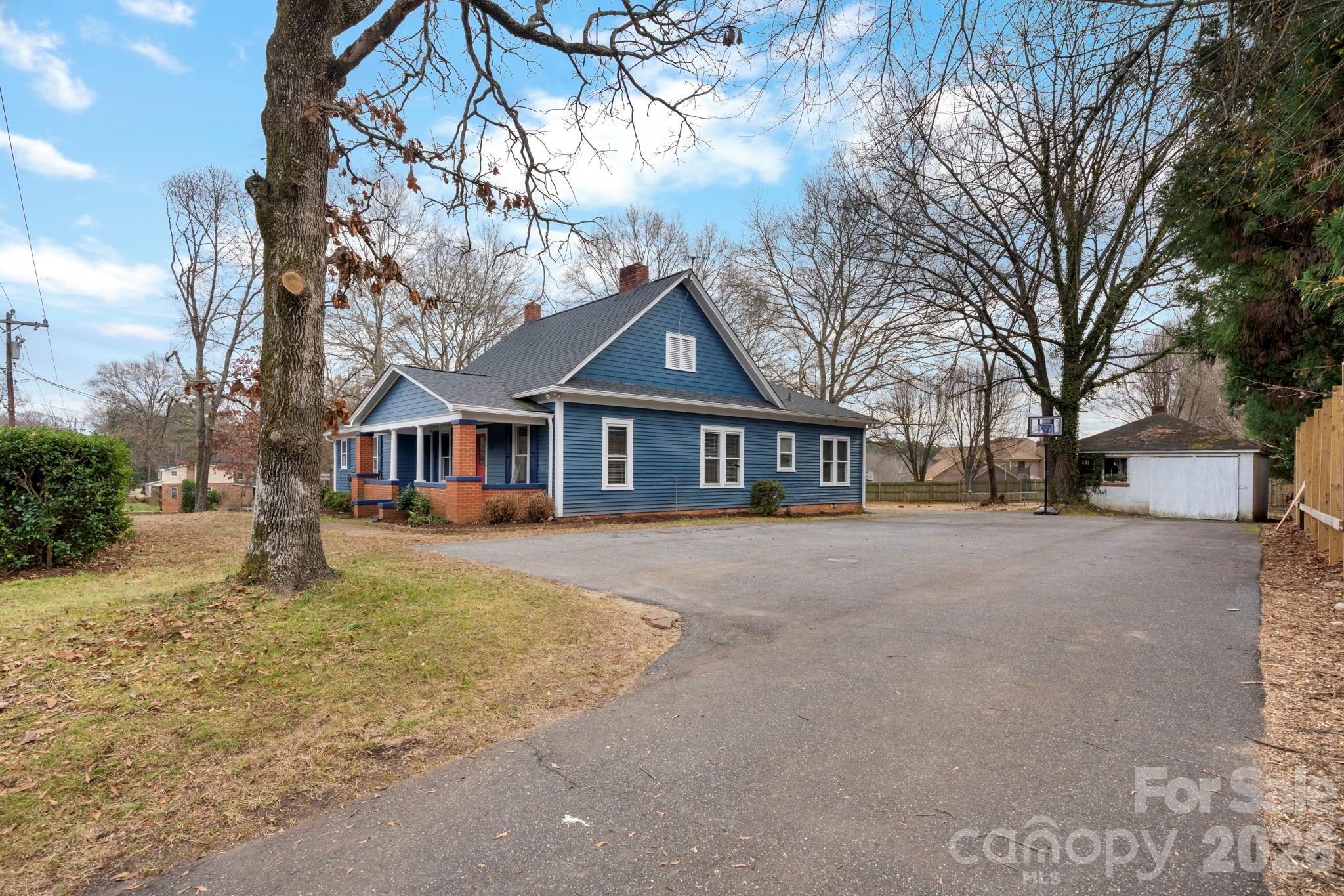 925 12th Avenue Northwest Hickory, NC 28601 - Photo 17 of 19 a front view of a house with a yard and garage