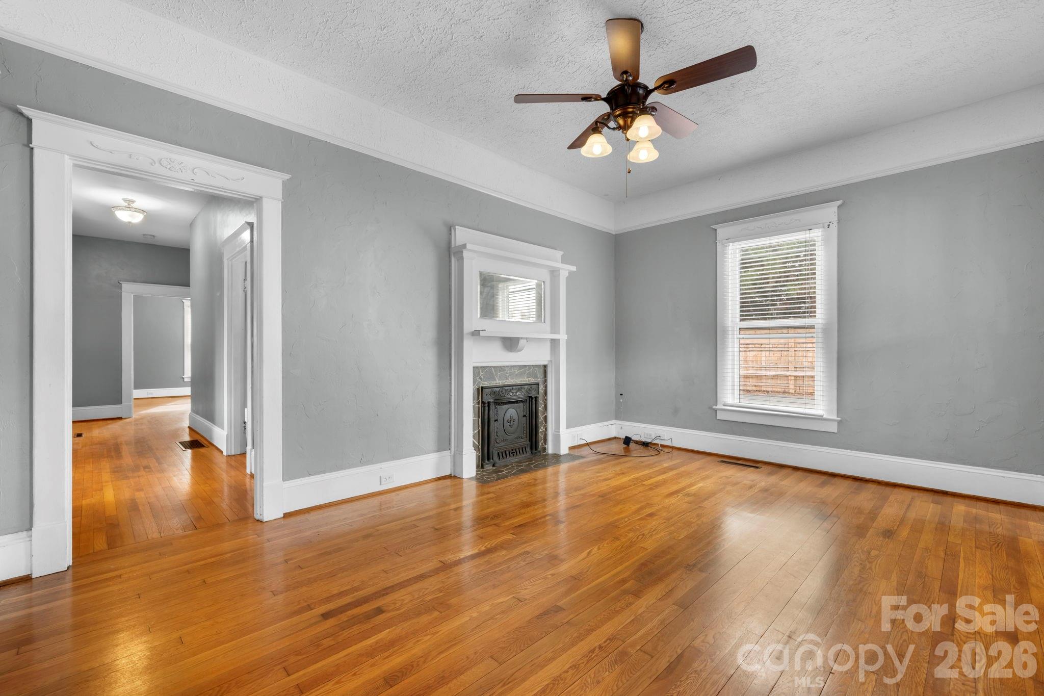 925 12th Avenue Northwest Hickory, NC 28601 - Photo 2 of 19 a view of an empty room with window and wooden floor