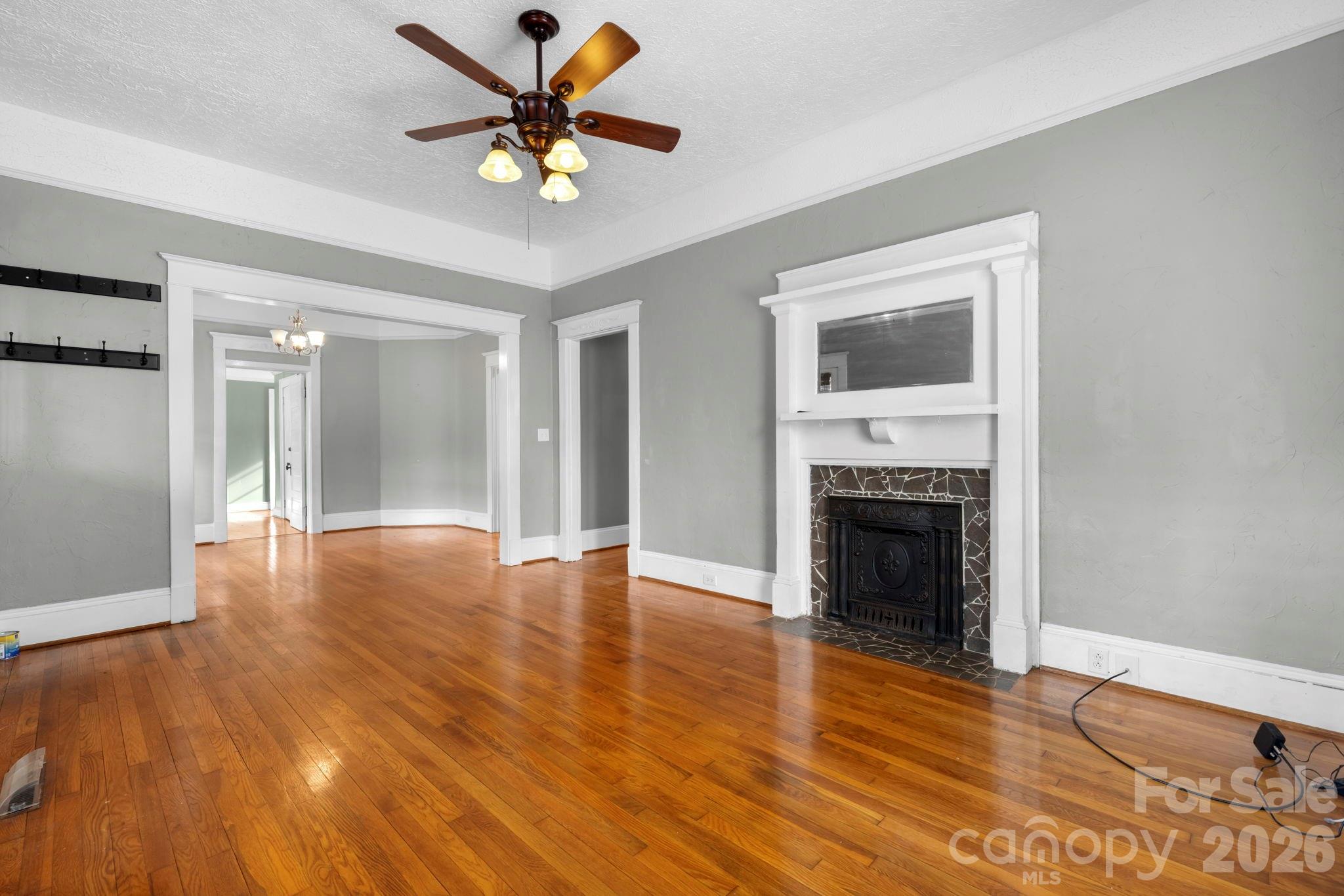 925 12th Avenue Northwest Hickory, NC 28601 - Photo 4 of 19 a view of an empty room with wooden floor and a fireplace