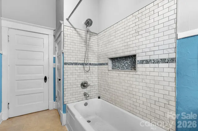 a bathroom with a bathtub and shower