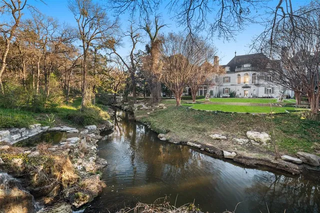 a view of a lake with a house in the background
