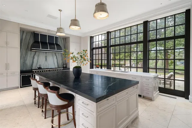 a kitchen with a table chairs and a chandelier