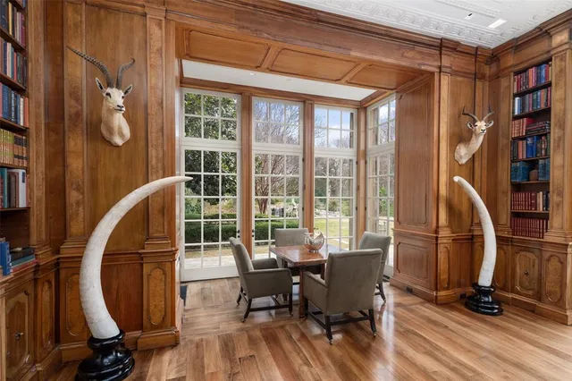a view of a workspace with furniture and a floor to ceiling window