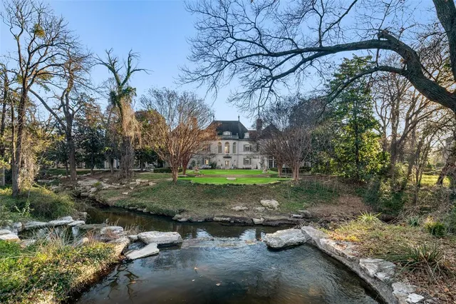 a view of a yard with large trees