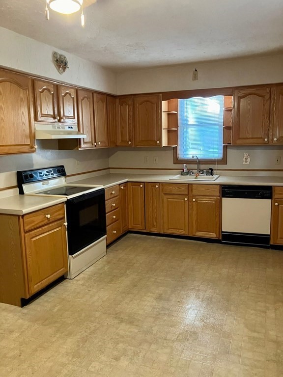 23 Carver Street Worcester, MA 01604 - Photo 11 of 27 a kitchen with stainless steel appliances granite countertop a stove sink and cabinets