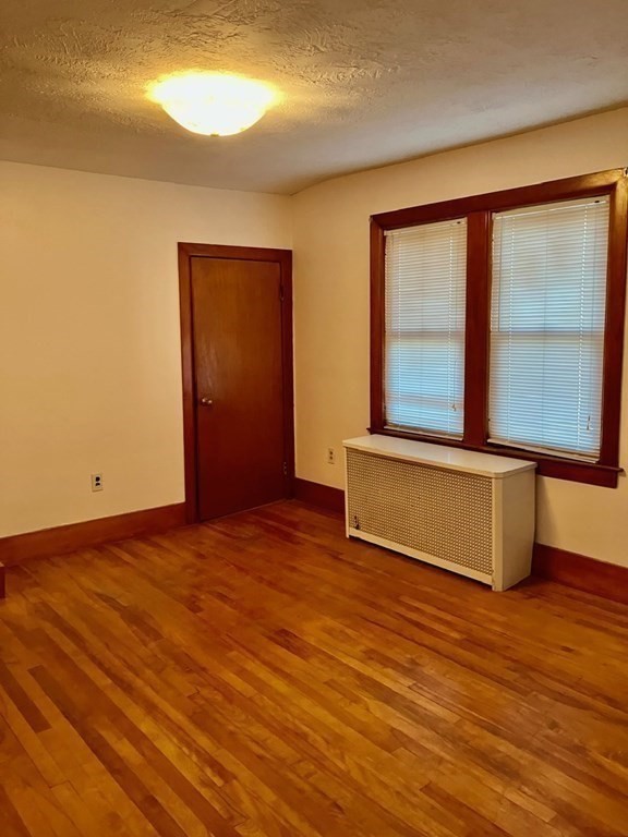 23 Carver Street Worcester, MA 01604 - Photo 21 of 27 a view of an empty room with wooden floor and a window
