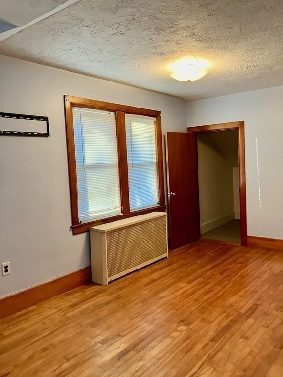 23 Carver Street Worcester, MA 01604 - Photo 22 of 27 a view of an empty room with wooden floor and a window