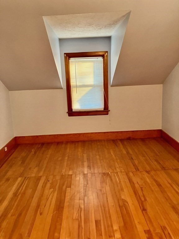 23 Carver Street Worcester, MA 01604 - Photo 25 of 27 a view of empty room with wooden floor and fan