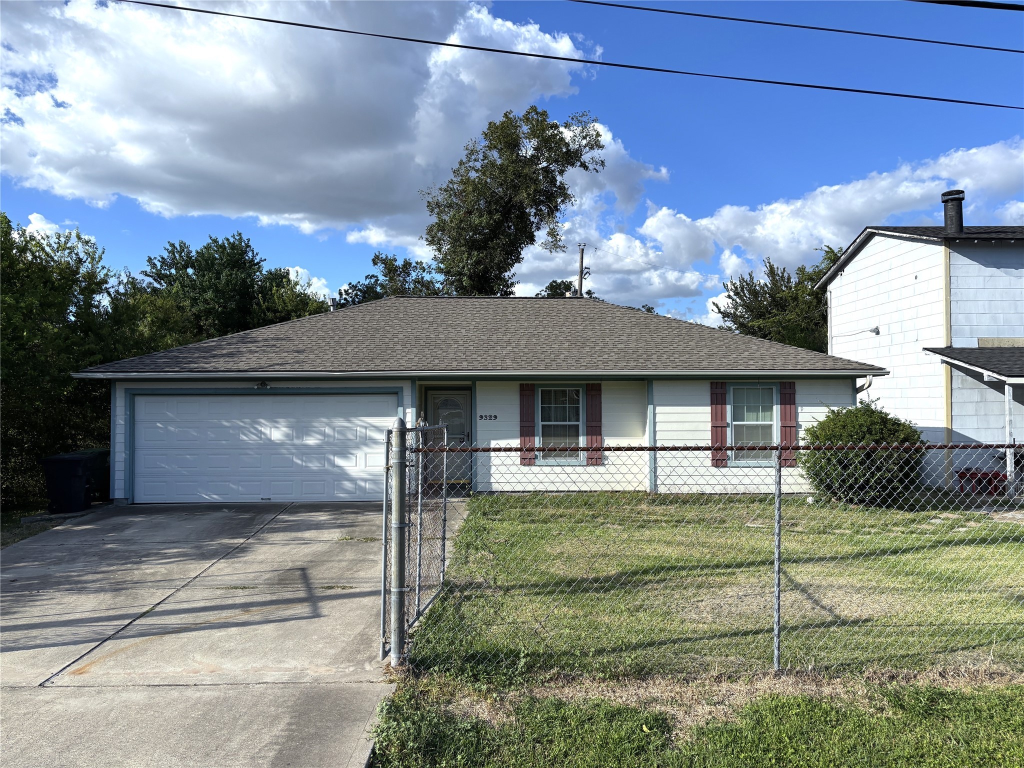 9329 Intervale Street Houston, TX 77075 - Photo 2 of 11 a front view of a house with a garden