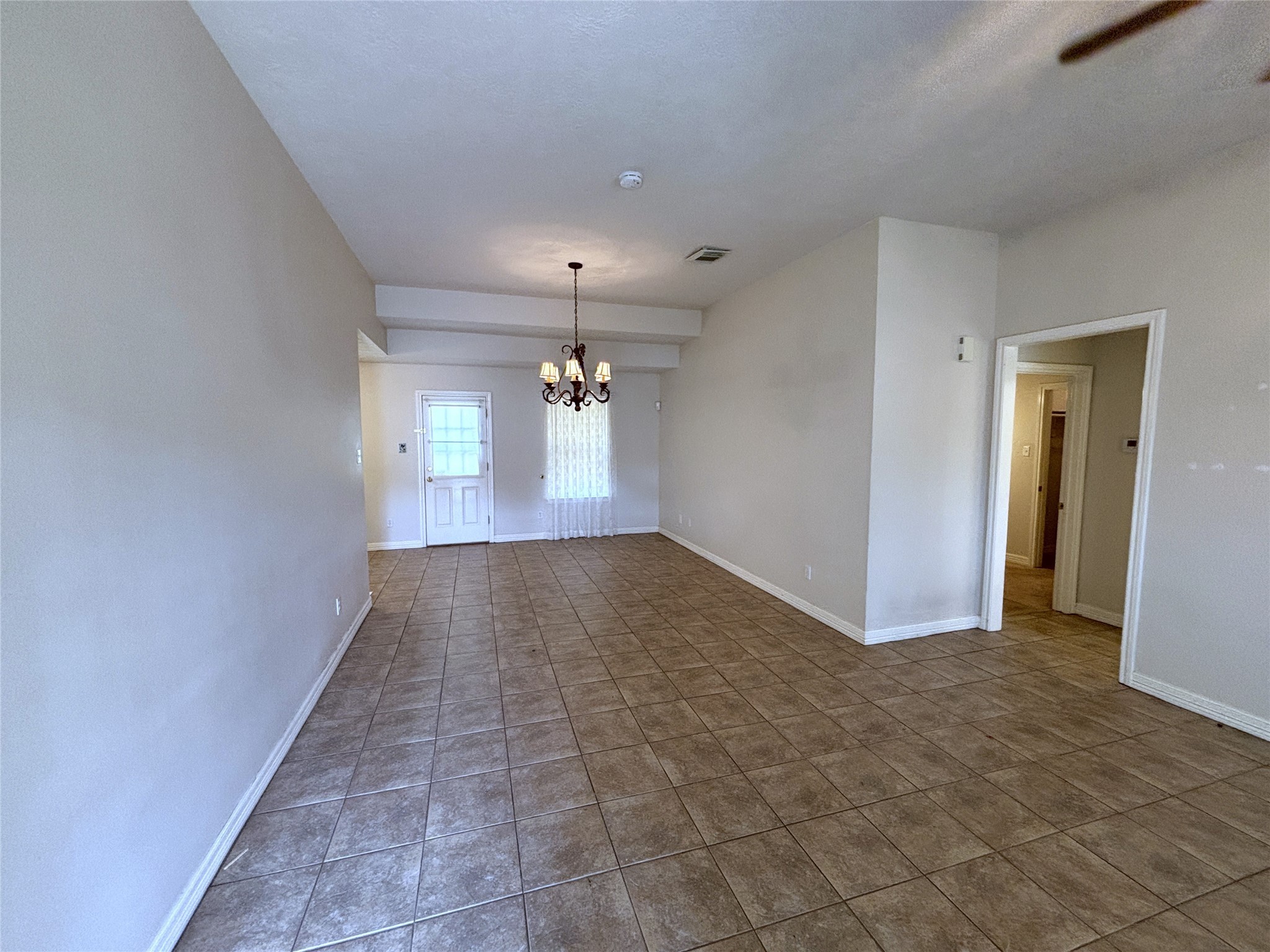 9329 Intervale Street Houston, TX 77075 - Photo 3 of 11 a view of a hallway with chandelier and glass door
