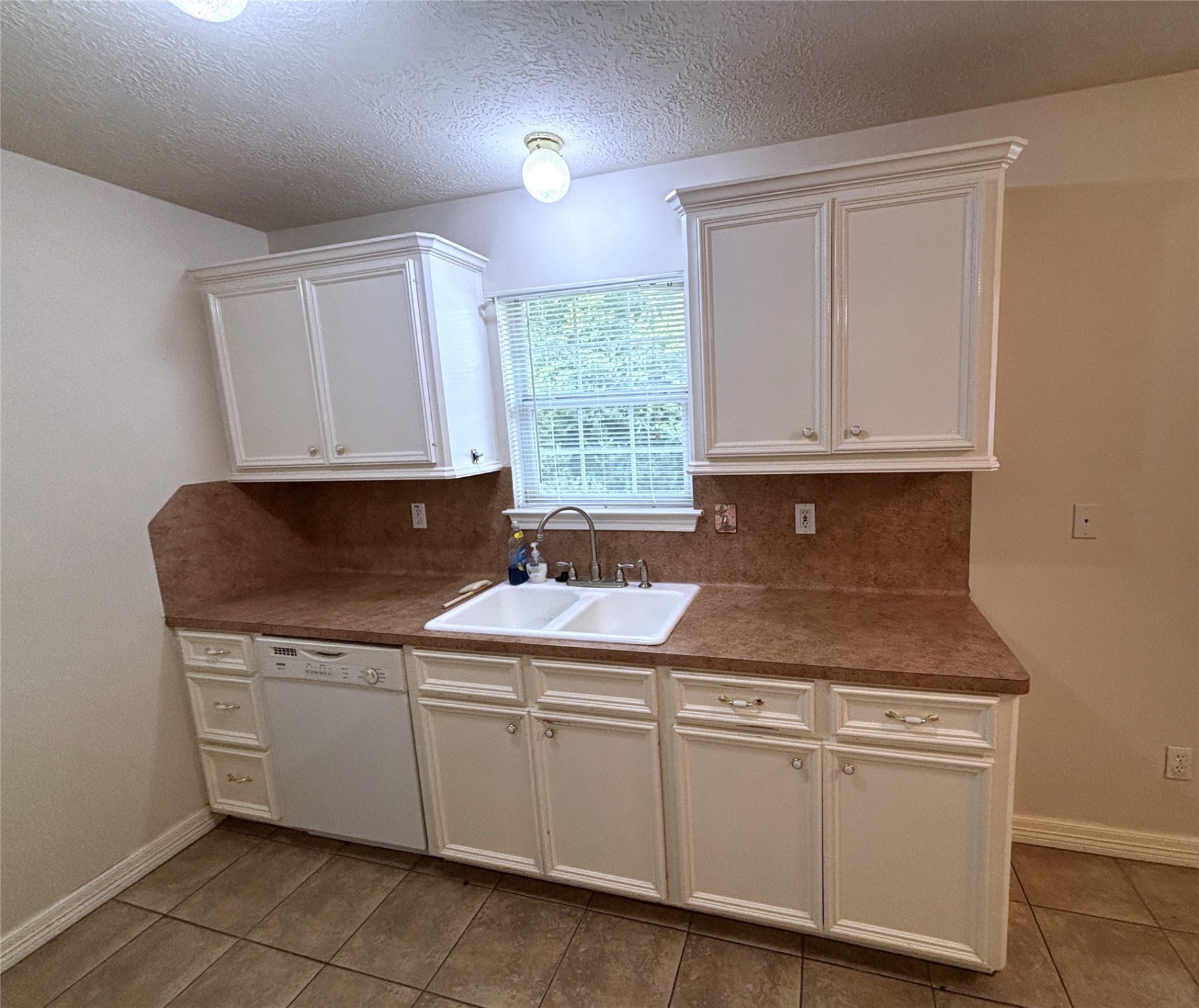 9329 Intervale Street Houston, TX 77075 - Photo 5 of 11 a view of cabinets a sink and dishwasher in a white cabinet