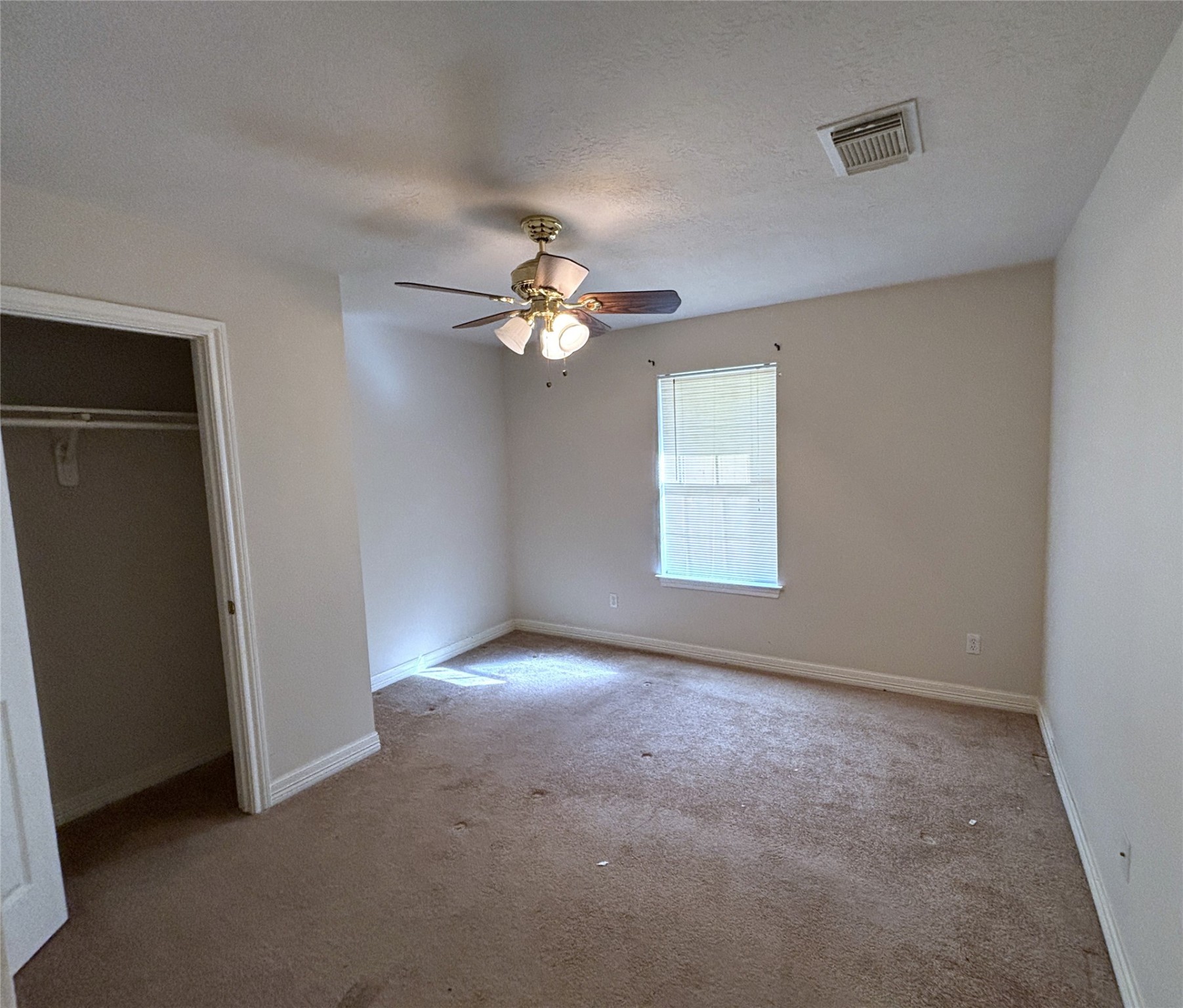 9329 Intervale Street Houston, TX 77075 - Photo 7 of 11 an empty room with windows and fan
