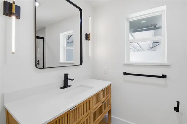 a bathroom with a sink and a mirror