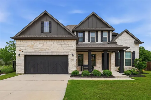 a front view of a house with a yard and garage